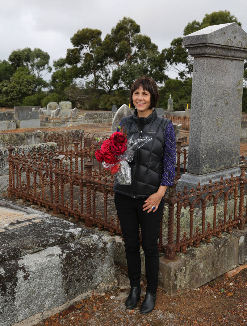 event organiser Maryanne Martin visits the grave of David Millard, Condah cemetery, to place flowers. Millard was gassed during the war but just managed to get home and died in October 1918.